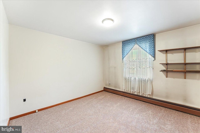 carpeted empty room featuring a baseboard radiator