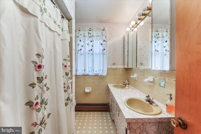 bathroom with a baseboard radiator, vanity, a shower with shower curtain, and tile walls