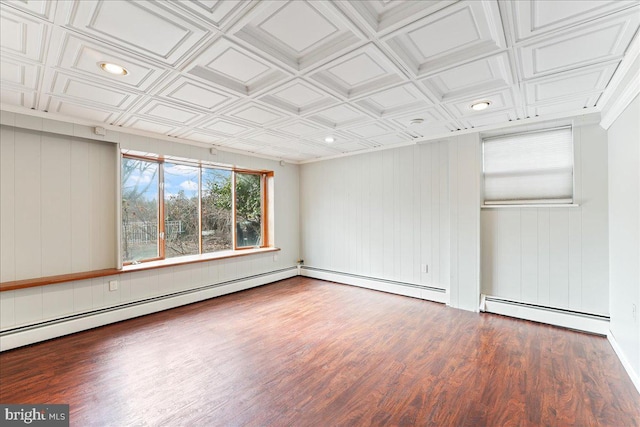 spare room with hardwood / wood-style floors and baseboard heating