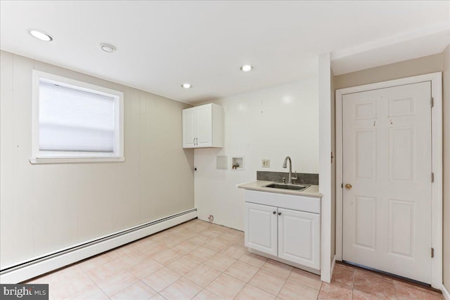 laundry area with hookup for a washing machine, a baseboard radiator, sink, and cabinets