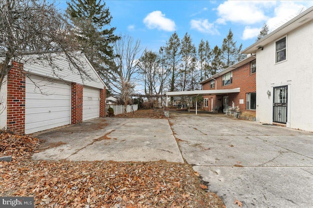 exterior space with a garage and an outbuilding