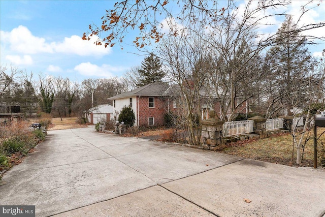 view of side of property featuring an outbuilding and a garage