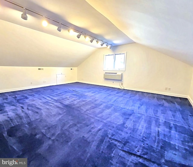 bonus room featuring vaulted ceiling, a wall unit AC, and carpet