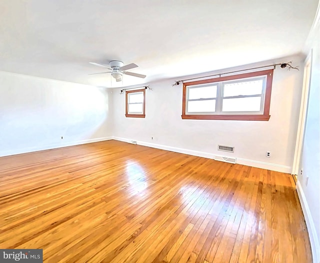 empty room featuring ceiling fan and light hardwood / wood-style floors