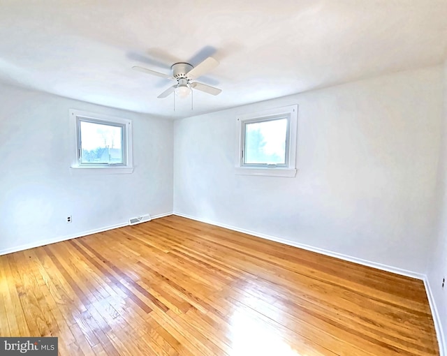 empty room with wood-type flooring and ceiling fan