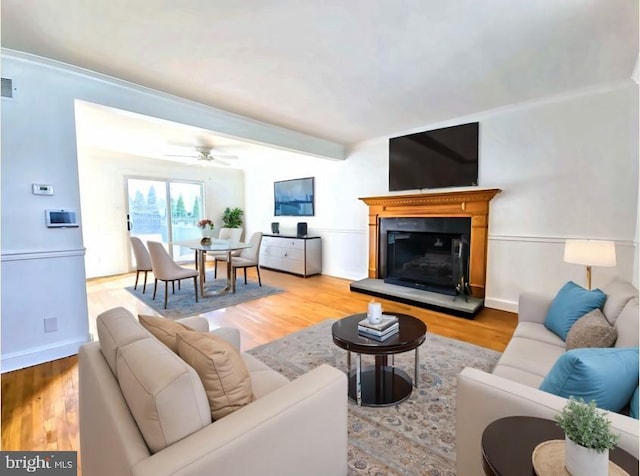 living room featuring ceiling fan and light hardwood / wood-style floors