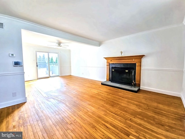 unfurnished living room with hardwood / wood-style flooring and ceiling fan