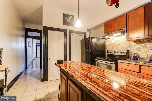 kitchen featuring pendant lighting, light tile patterned floors, stainless steel electric range, tasteful backsplash, and black fridge