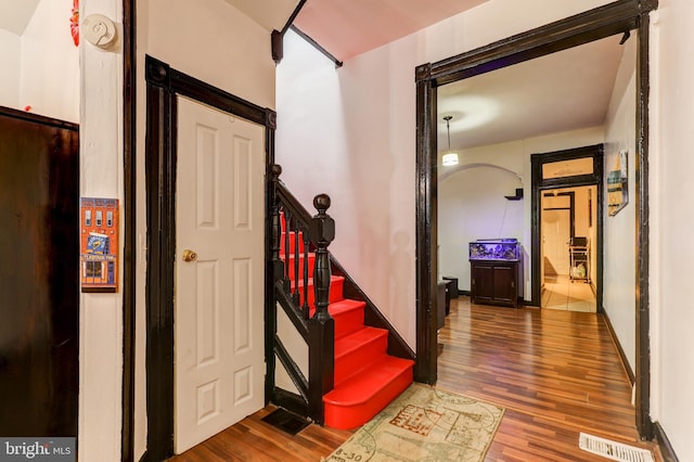 stairway with hardwood / wood-style flooring