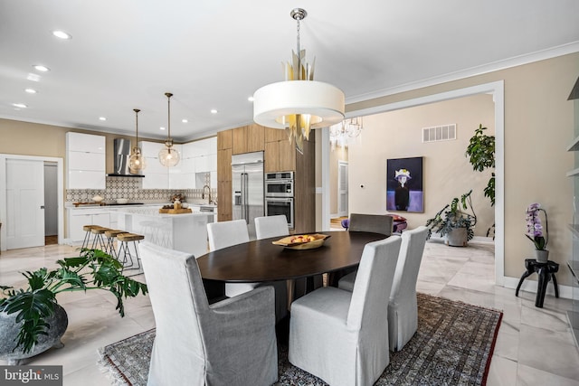 dining area featuring sink and crown molding