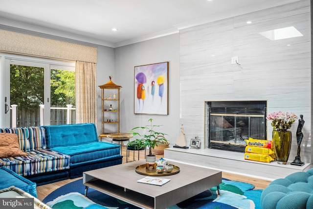 living room featuring crown molding, a premium fireplace, and hardwood / wood-style floors