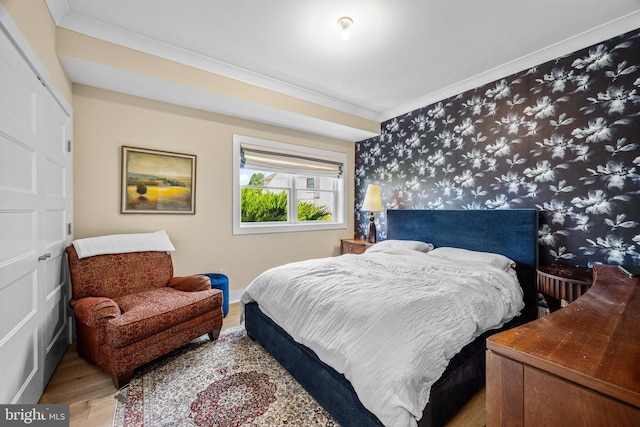 bedroom with hardwood / wood-style flooring and crown molding