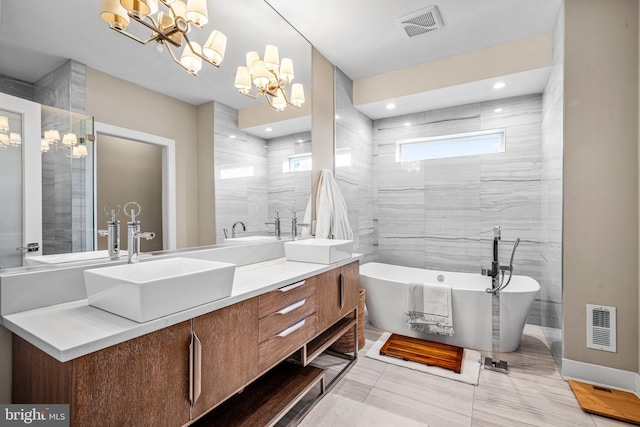 bathroom featuring vanity, a bath, and tile walls