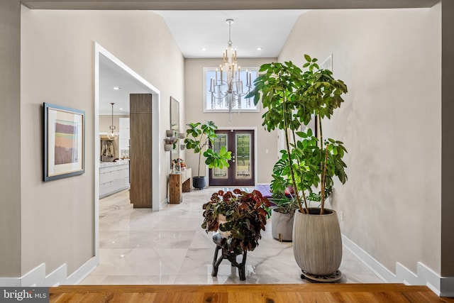 foyer featuring a chandelier and french doors