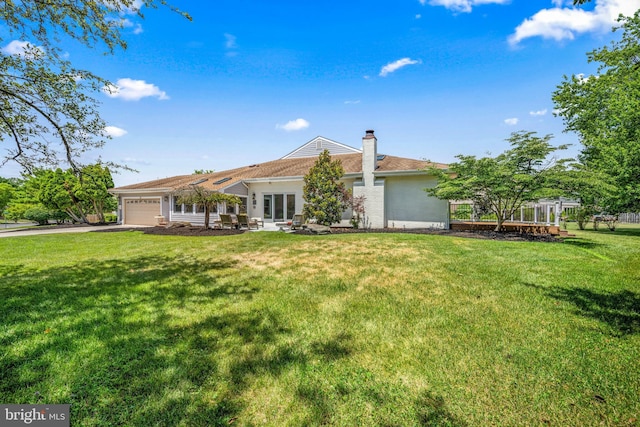 view of front of home with a garage and a front yard