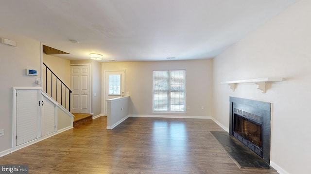 unfurnished living room featuring dark hardwood / wood-style floors