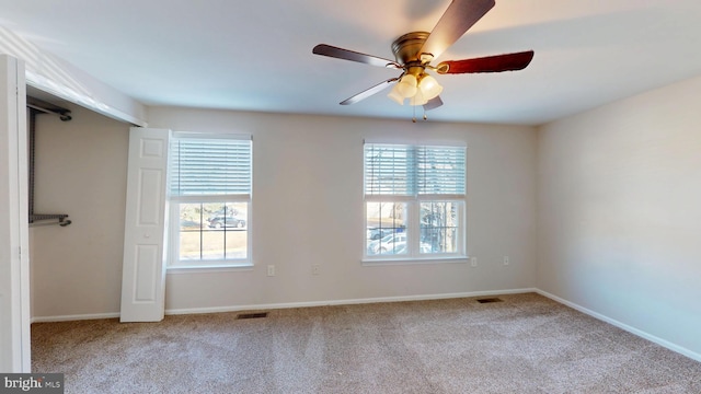 carpeted empty room featuring ceiling fan