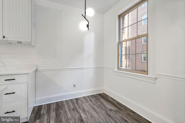 unfurnished dining area featuring dark hardwood / wood-style floors