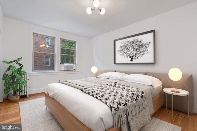 bedroom featuring cooling unit and wood-type flooring