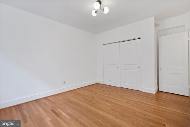 unfurnished bedroom with a closet and light hardwood / wood-style flooring