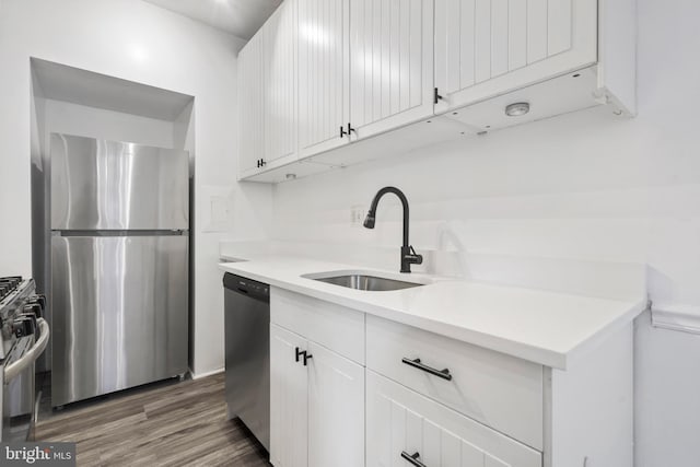 kitchen featuring sink, stainless steel appliances, dark hardwood / wood-style floors, and white cabinets