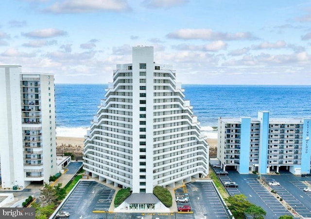 view of building exterior with a view of the beach and a water view