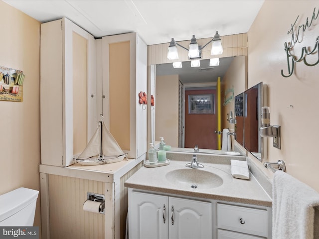 bathroom featuring vanity and toilet