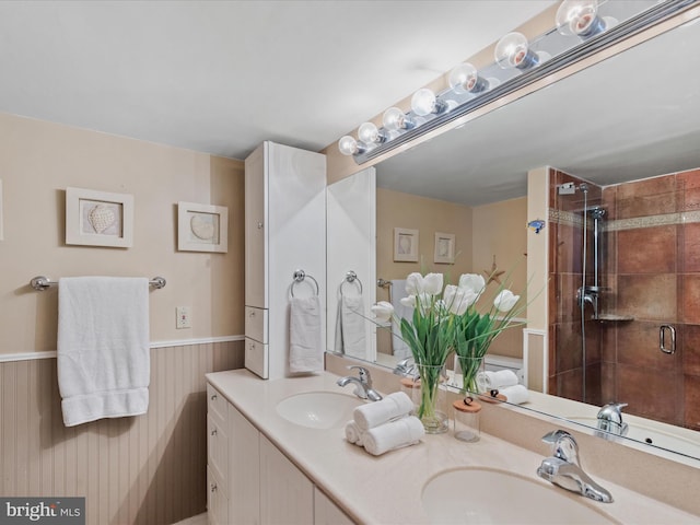 bathroom with vanity, tiled shower, and wood walls