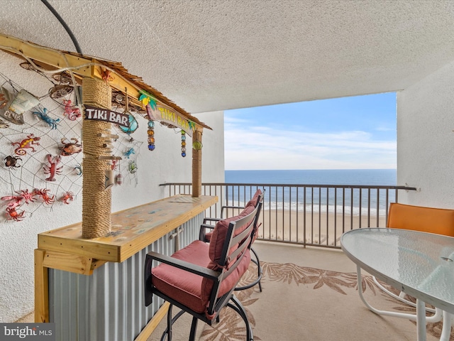 balcony with a view of the beach and a water view