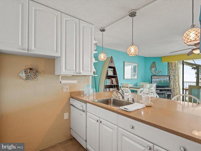 kitchen with white cabinetry, dishwasher, sink, and hanging light fixtures