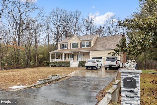 view of front of house featuring a garage and a porch