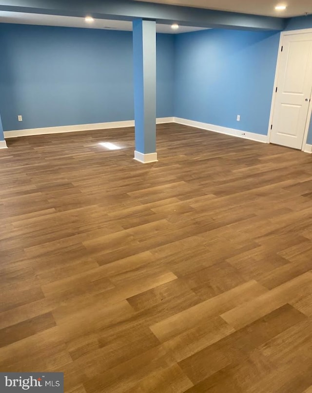 basement with hardwood / wood-style floors