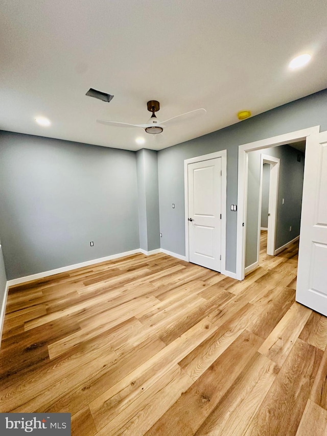 unfurnished room with hardwood / wood-style floors and ceiling fan