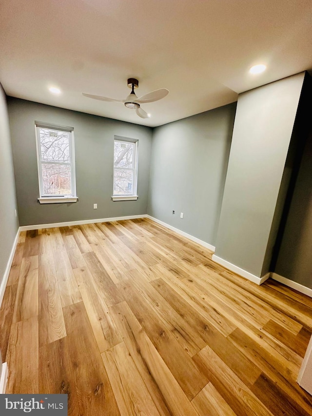 unfurnished room with wood-type flooring and ceiling fan