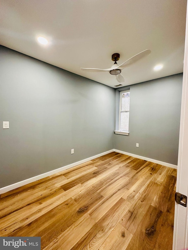 spare room with hardwood / wood-style floors and ceiling fan