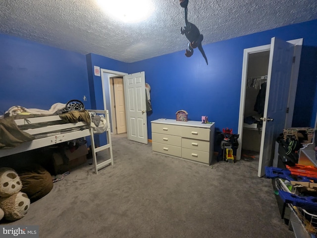 bedroom featuring carpet floors, a closet, and a textured ceiling