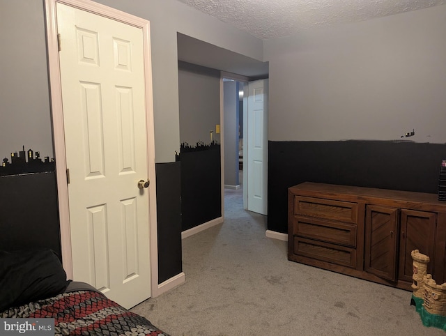 carpeted bedroom with a textured ceiling