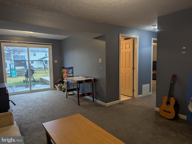 carpeted living room with a textured ceiling