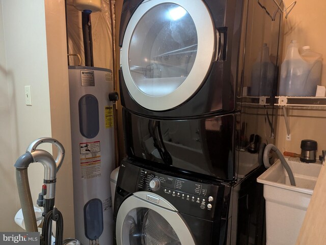 clothes washing area with stacked washer / dryer, electric water heater, and sink