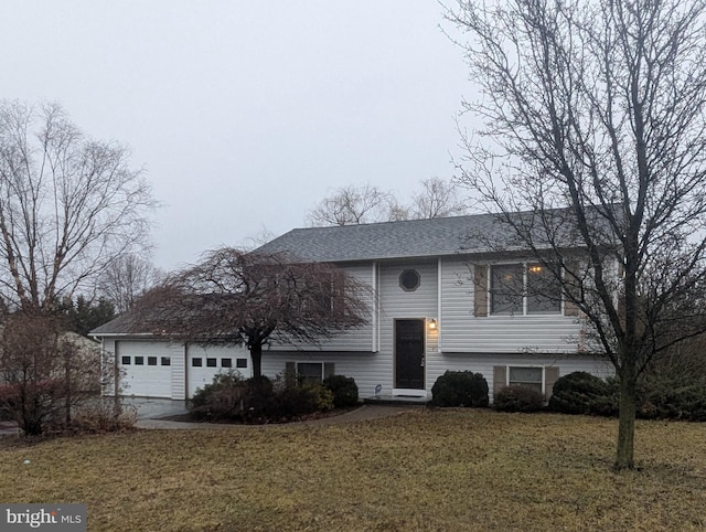 view of front of house with a garage and a front lawn