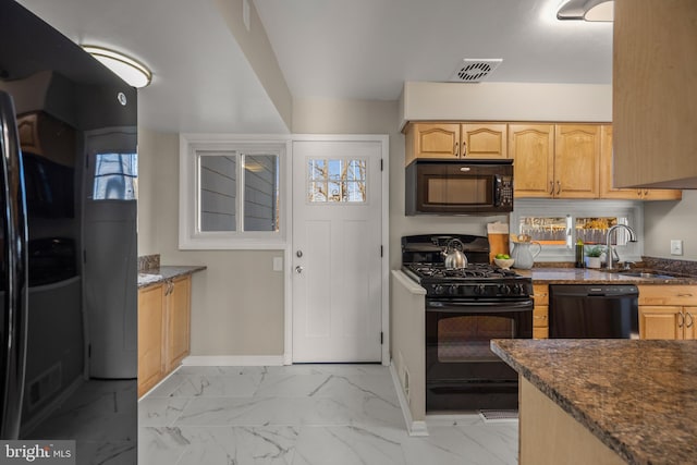 kitchen featuring dark stone countertops, sink, black appliances, and light brown cabinets