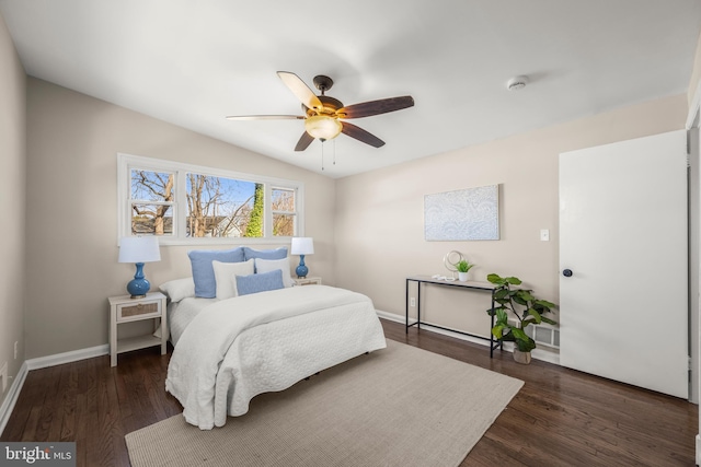 bedroom featuring lofted ceiling, dark wood-type flooring, and ceiling fan