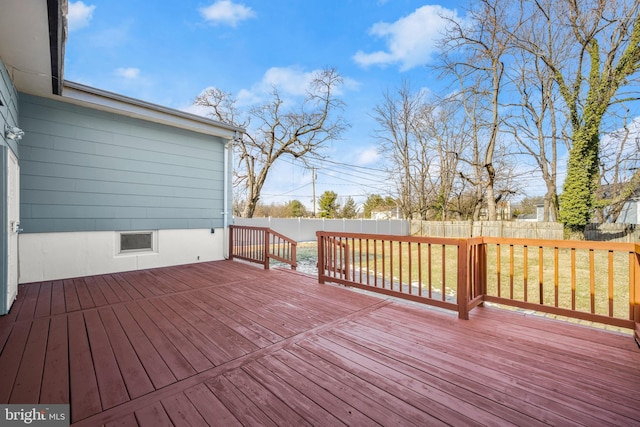 wooden deck featuring a lawn