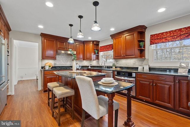 kitchen with open shelves, light wood-style floors, a sink, oven, and under cabinet range hood