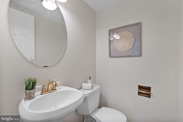 bathroom with toilet and a sink