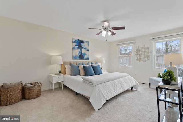 bedroom with light carpet, ceiling fan, and baseboards