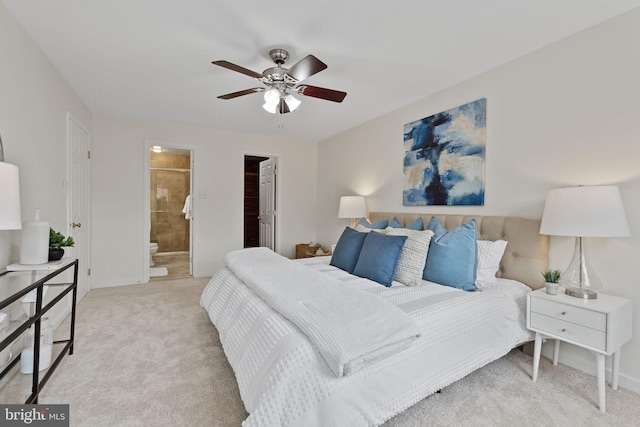 bedroom featuring carpet floors, ceiling fan, baseboards, and connected bathroom