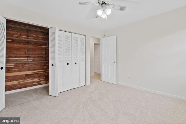 unfurnished bedroom featuring carpet floors, a closet, a ceiling fan, and baseboards