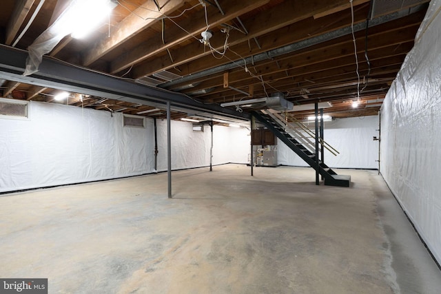 unfinished basement featuring stairway