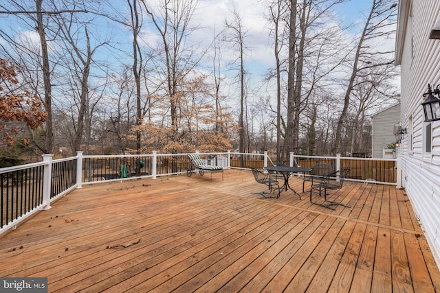 wooden terrace featuring outdoor dining space